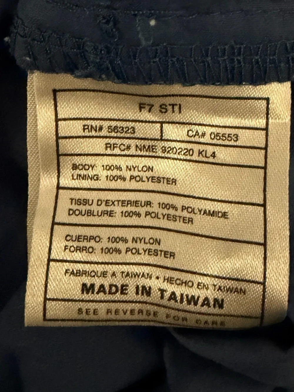 Nike Red Swoosh on White Brand Tag with Blue Fabric